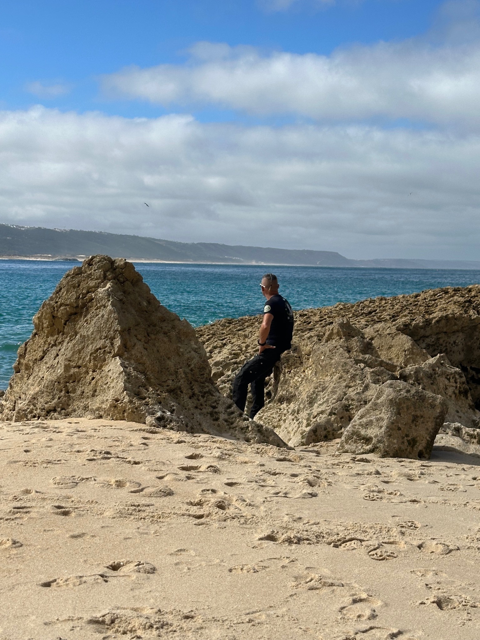 Sven Hardt among rocks by the sea